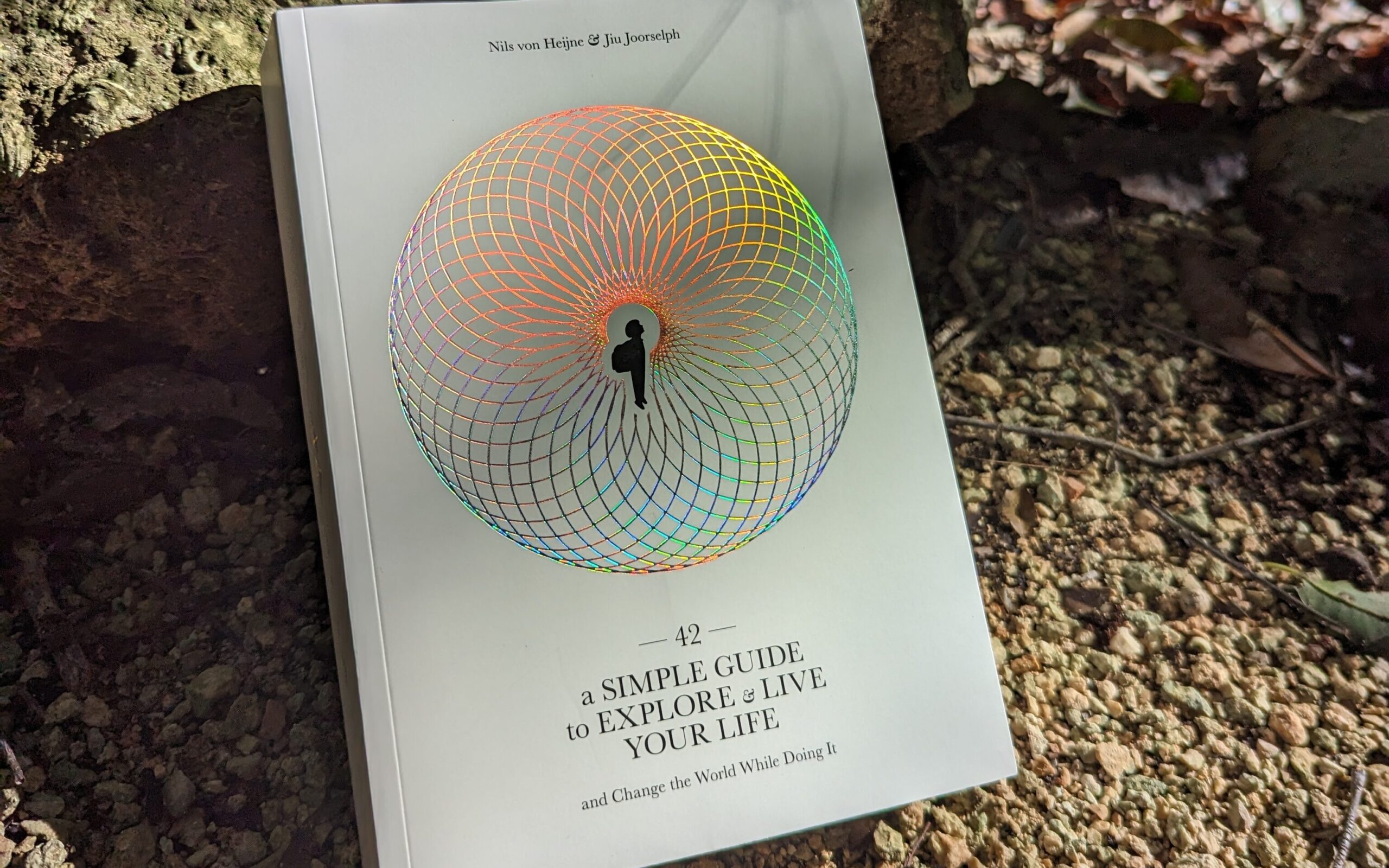 42, the printed book, resting on a forest floor